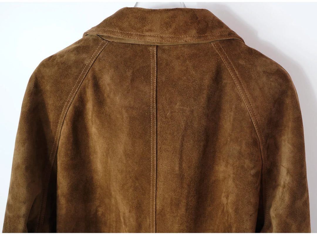 Close-up of brown suede coat back with center seam and stand collar