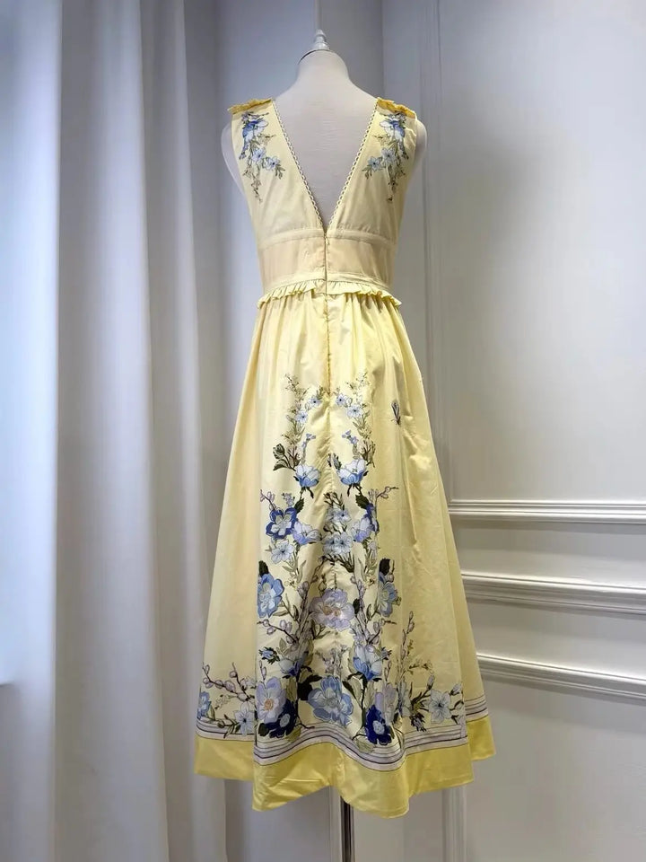 Light yellow floral midi dress with shoulder ruffles, V-neck, and gathered waist