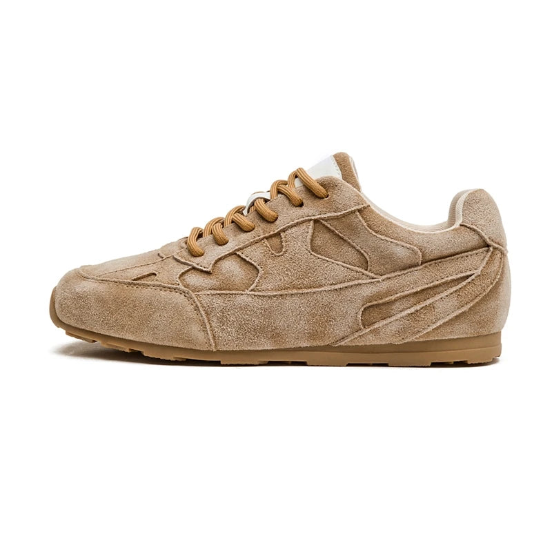 Tan suede women’s flat sneakers with lace-up design and textured rubber outsole