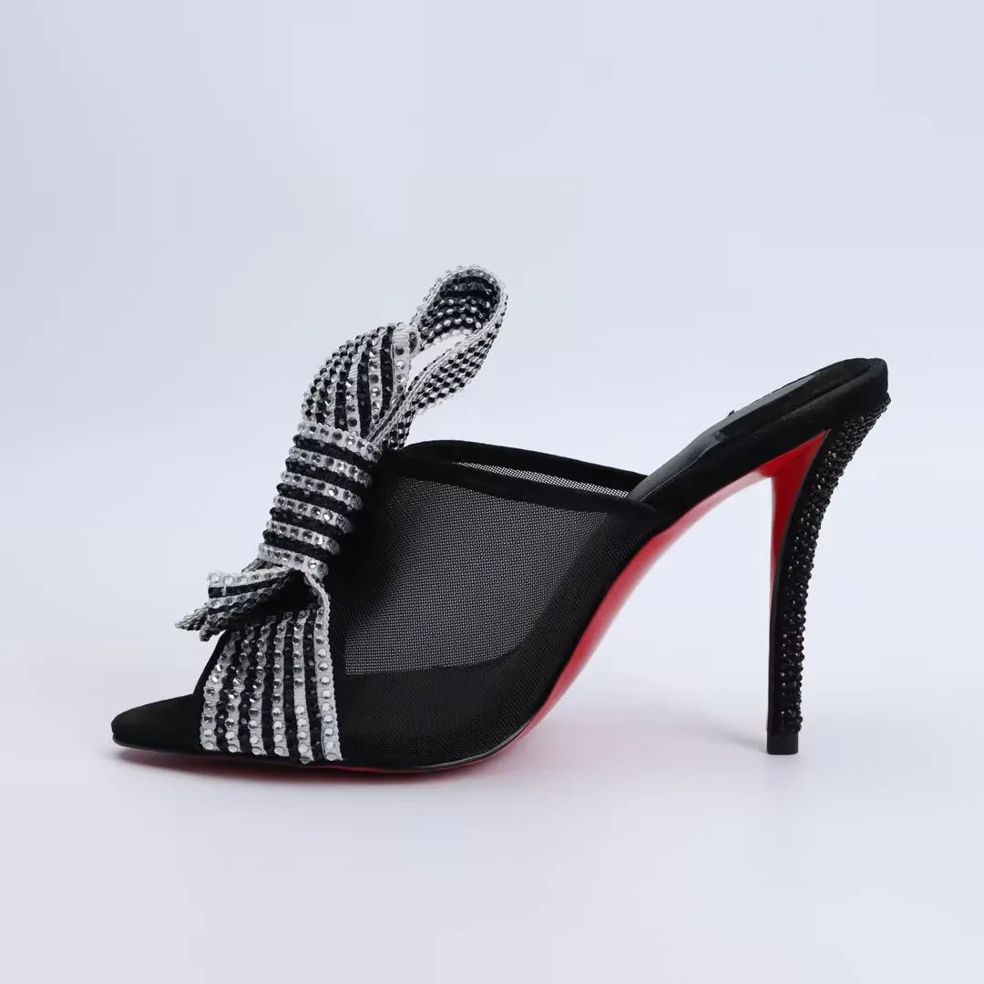 Black high-heel mule sandals with rhinestone-striped mesh bow detail at vamp and open toe