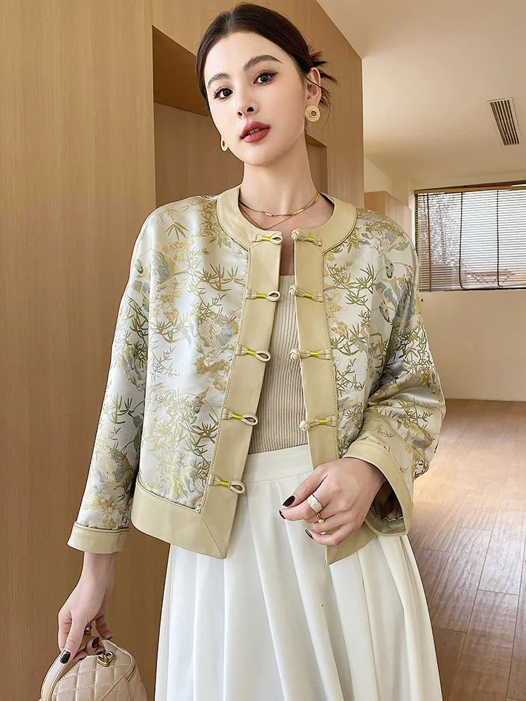 Women’s silk-leather coat in creamy yellow with botanical print and green snap placket
