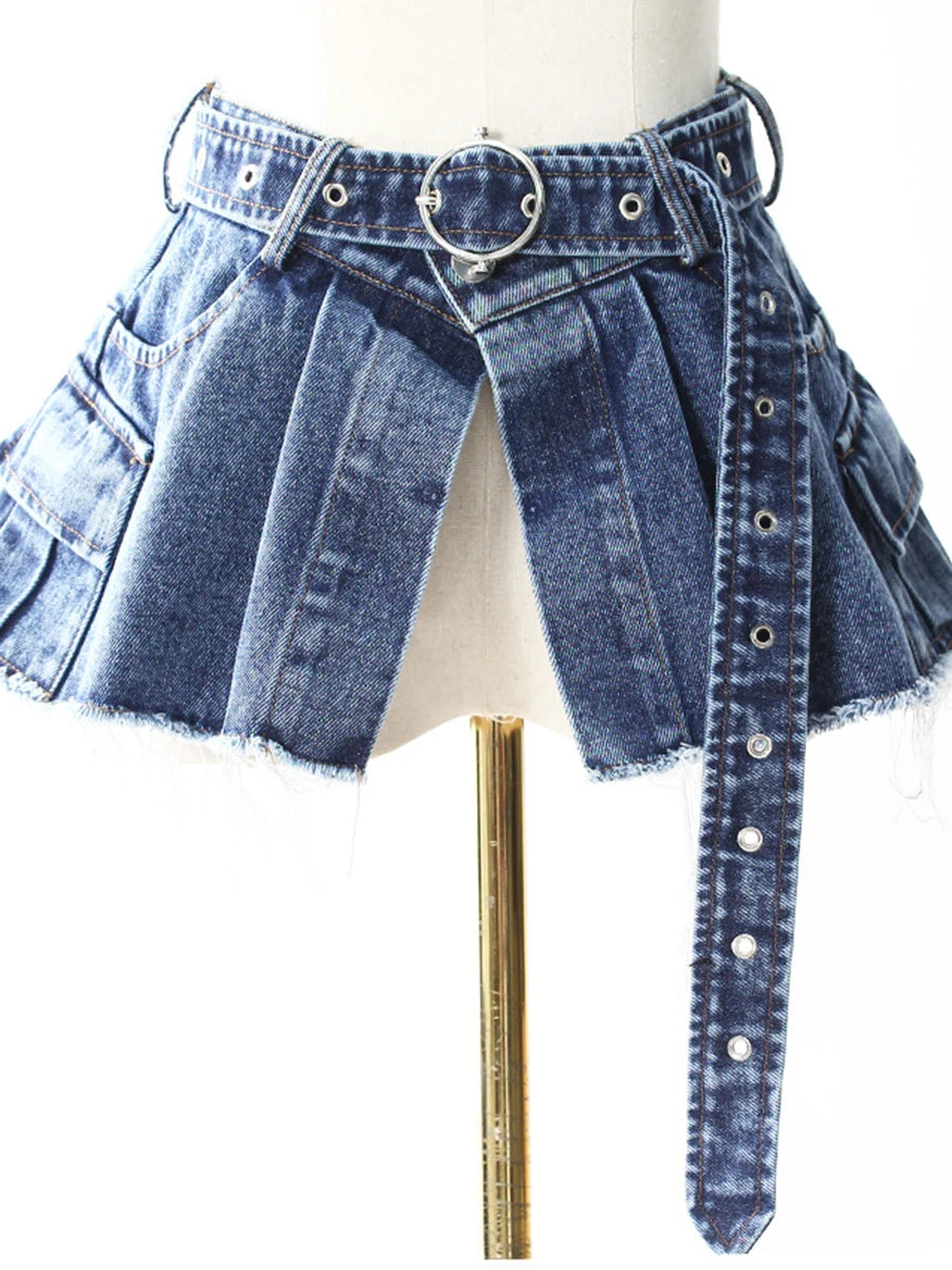 Dark blue denim flared skirt with multi-panel pleats, silver grommet belt, frayed hem