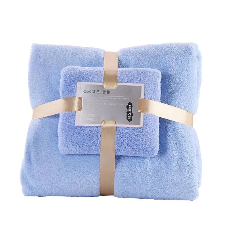 Light blue plush bath towel set, two folded towels tied with ribbon