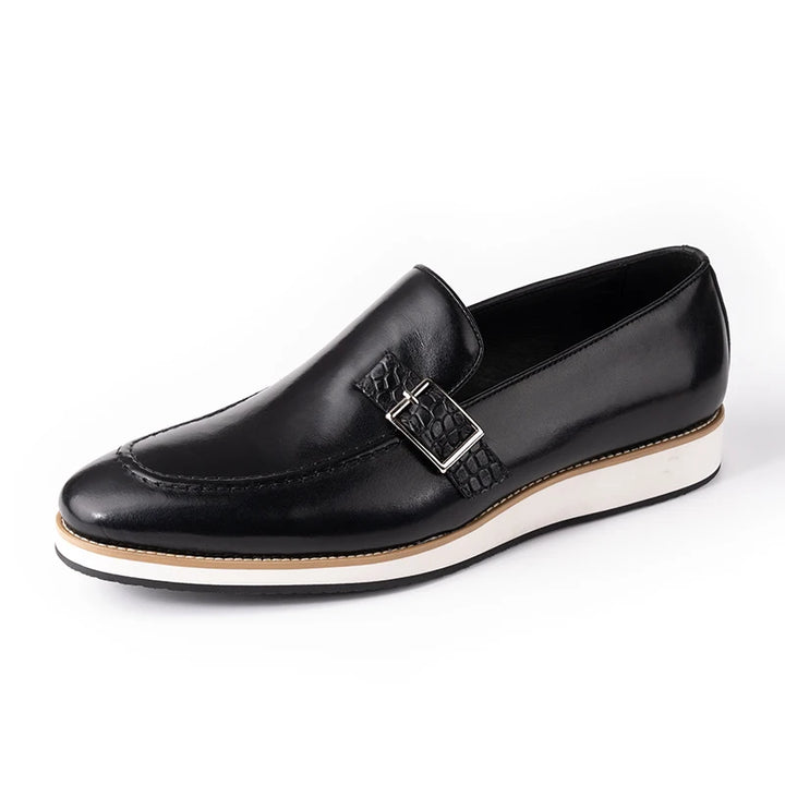 Black loafer shoe with a white sole on a white background