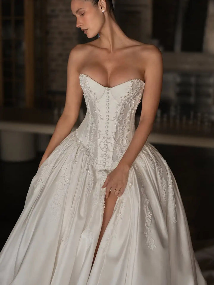 Ivory satin ballgown with corset bodice, lace details, and side high slit