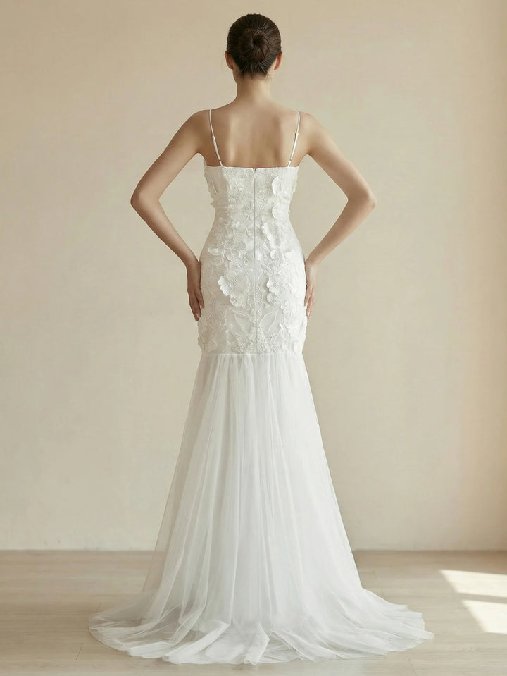 White appliqué bridal gown with spaghetti straps and tulle train