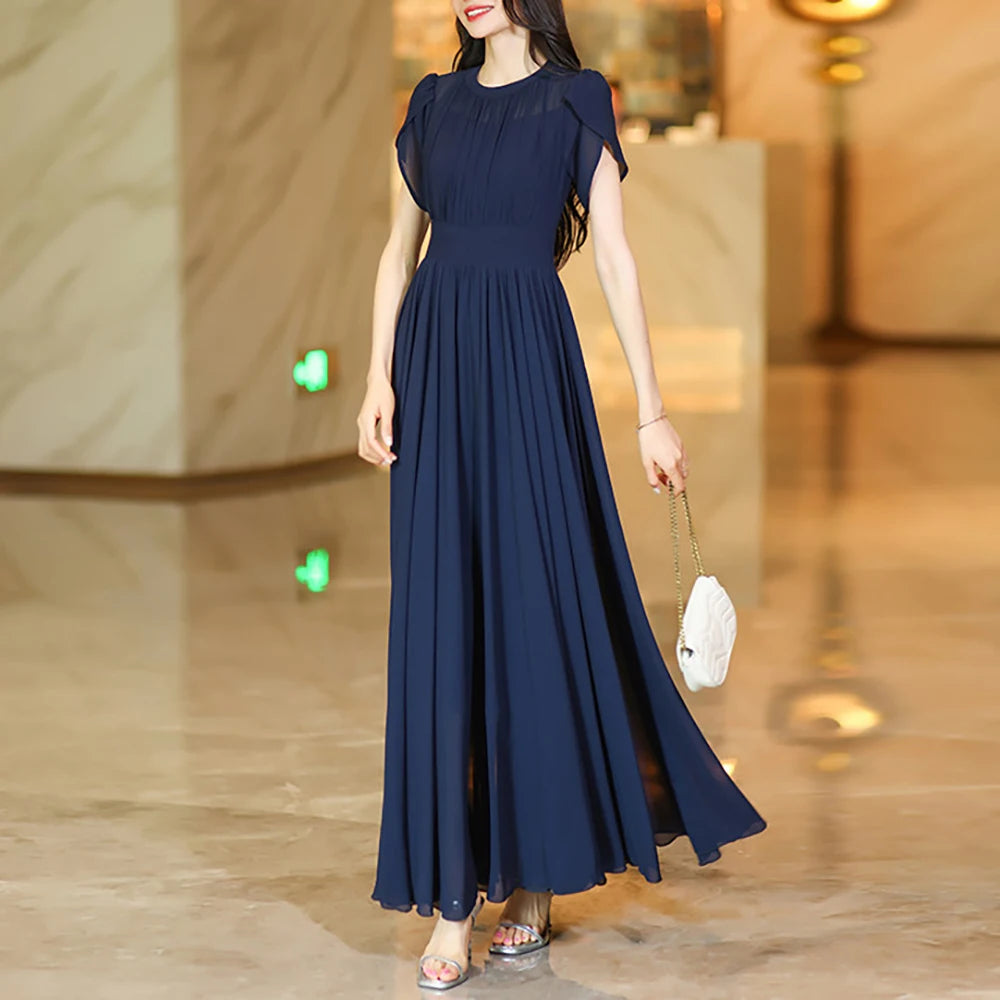 Navy A-line maxi skirt with pleated, flowing fabric and gathered waist