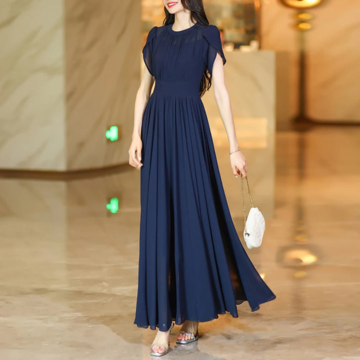 Navy A-line maxi skirt with pleated, flowing fabric and gathered waist