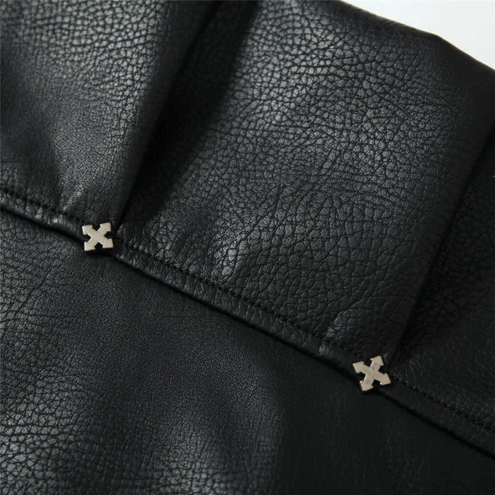 Close-up of black leather cuff with ribbed trim and stitched strap detail