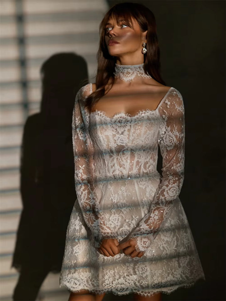 White lace bridal gown with long sleeves and fitted bodice