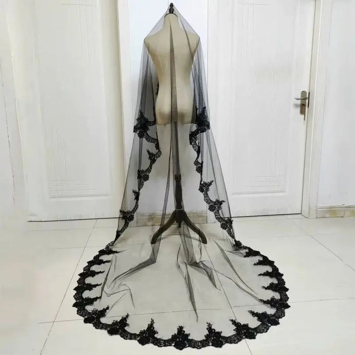 Black one-layer tulle bridal veil with lace edge and long train