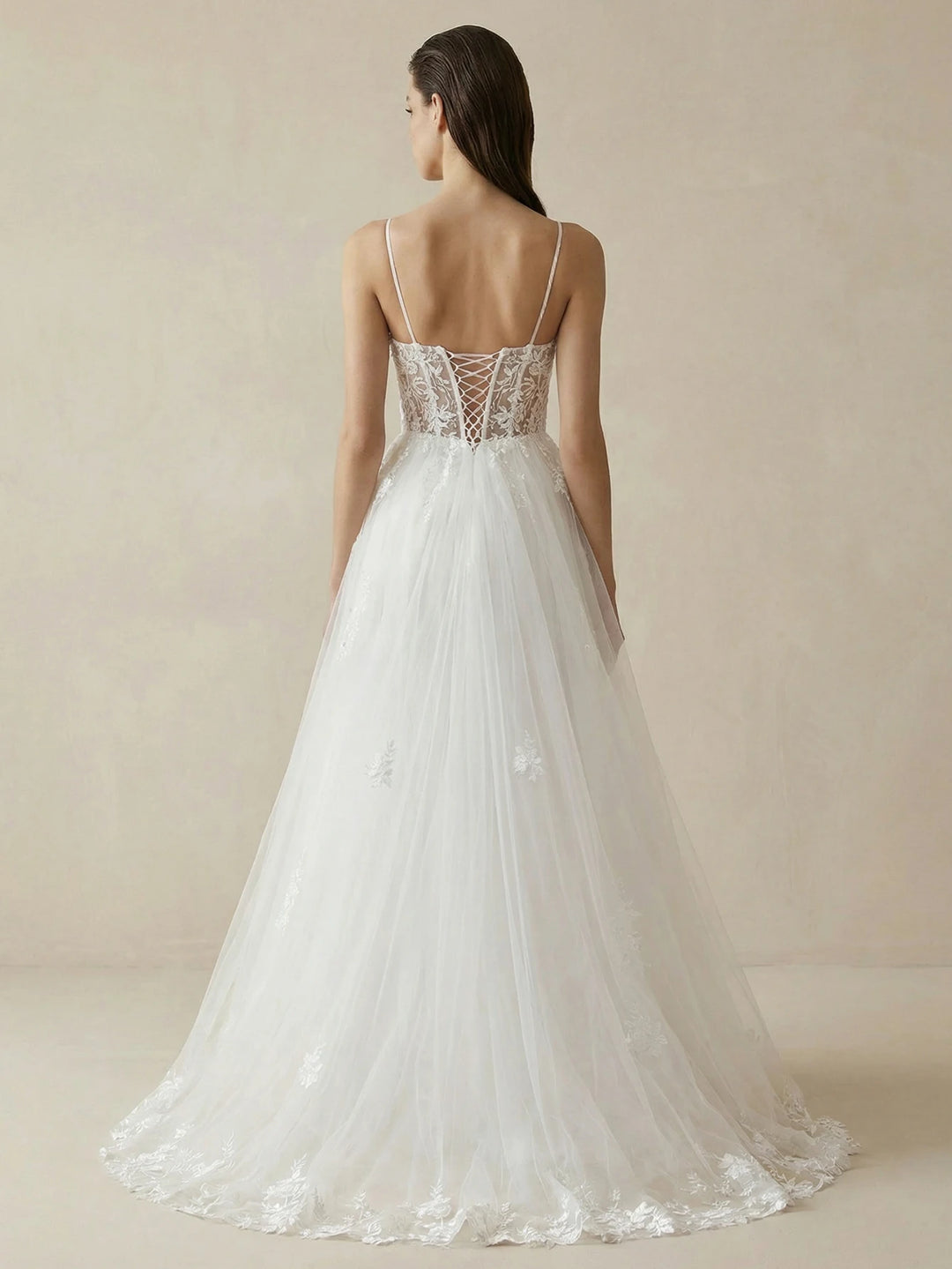White tulle bridal gown back view with lace bodice and flowing A-line skirt