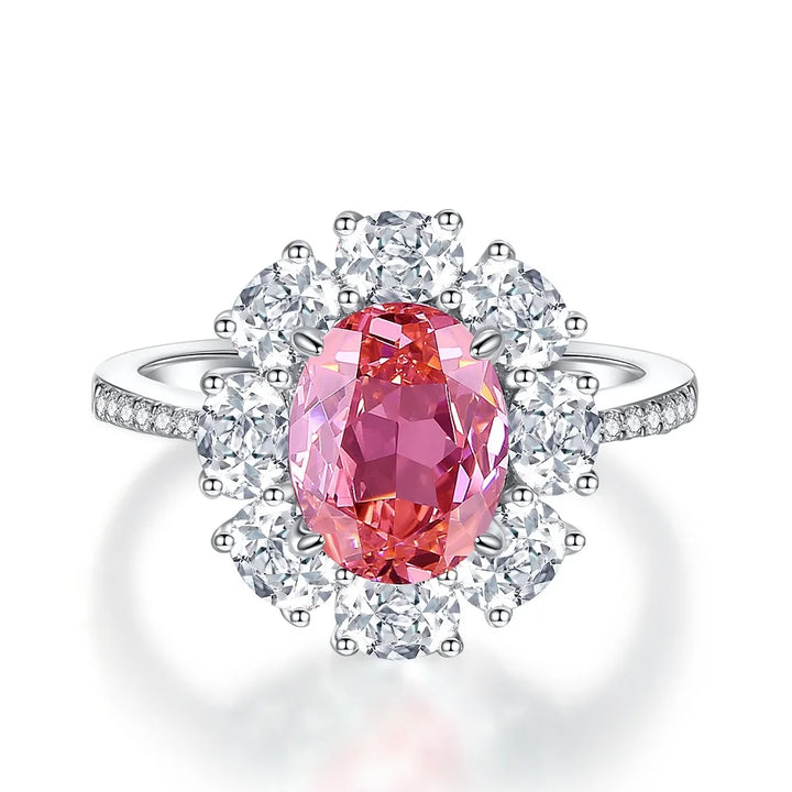 Diamond halo ring with oval pink center stone and round diamond accents