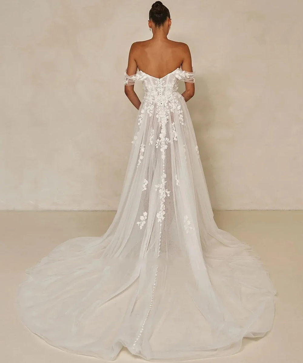 Off-shoulder floral lace bridal dress with long train, back view