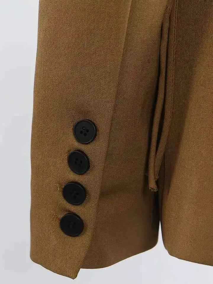 Brown blazer front close-up with four dark buttons and matching tailored lapels