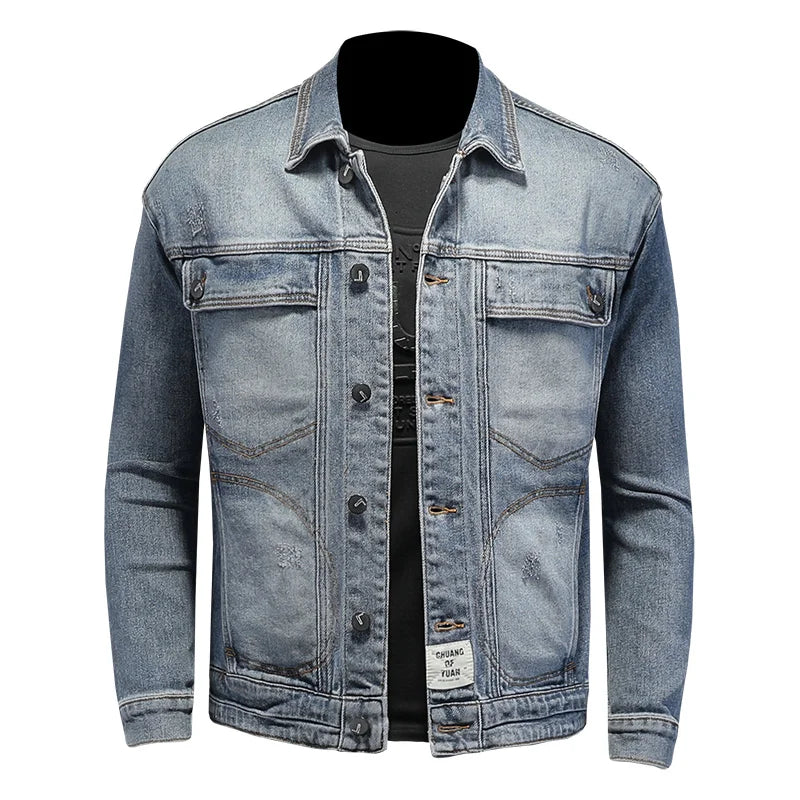 Light blue men’s denim jacket with button front, chest flap pockets, and denim cuffs