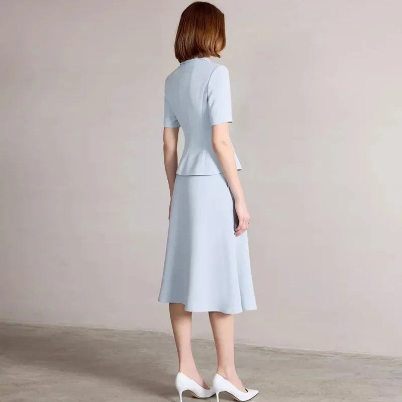Back view of light blue short-sleeve blazer and midi skirt suit
