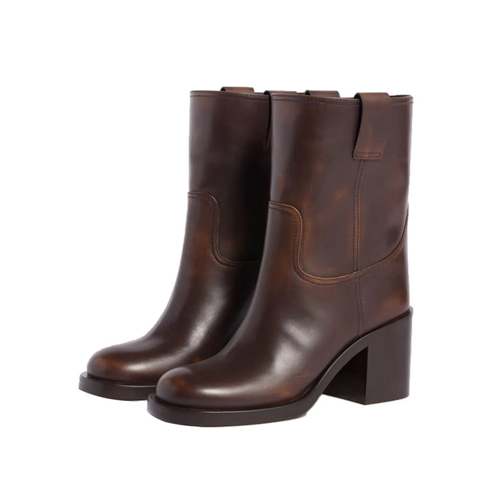 Brown pull-on ankle boots with round toe, stitched side panels, and block heel