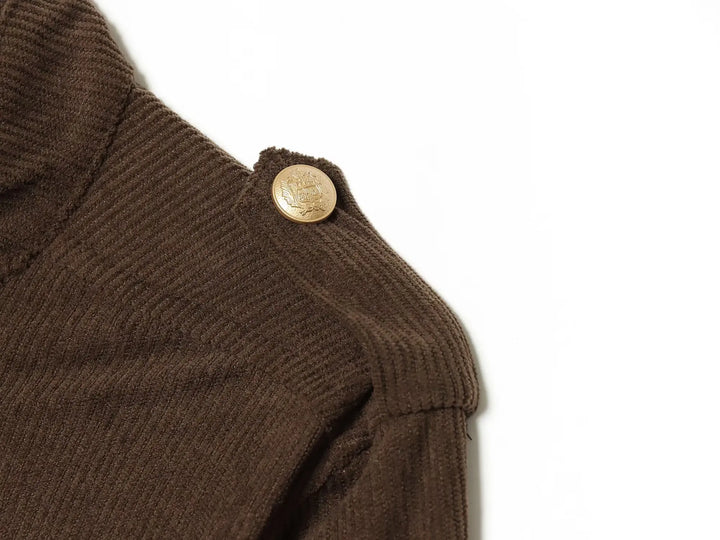 Brown coat shoulder with gold button and ribbed textured fabric