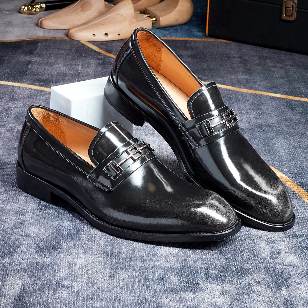 Black pointed toe leather loafers with buckle strap and tan lining