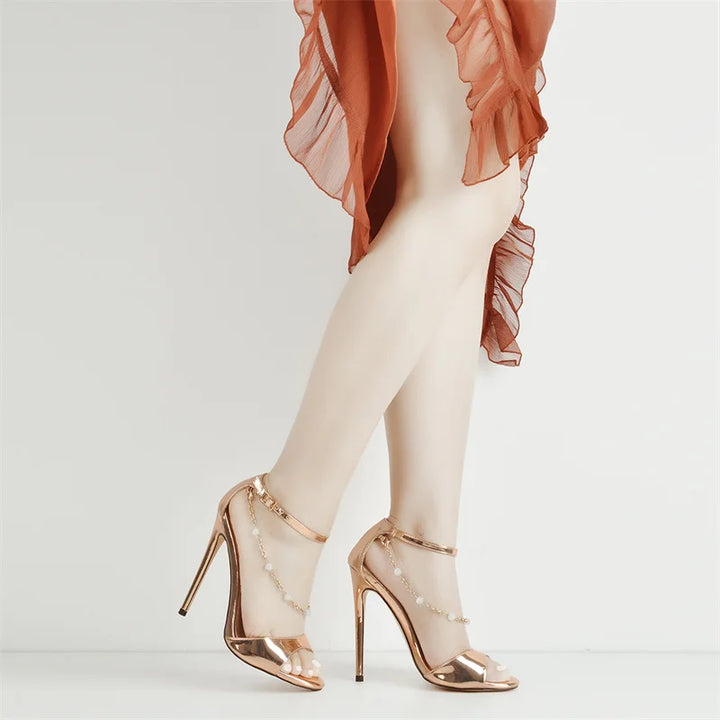 Metallic gold open-toe stiletto heel sandals with pearl-bead chain ankle straps