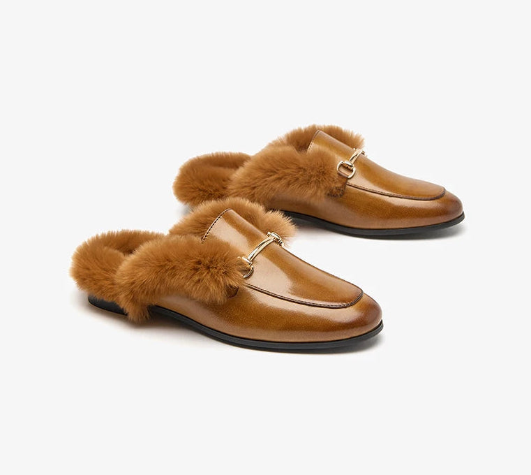 Pair of brown loafers with fur accents on a white background