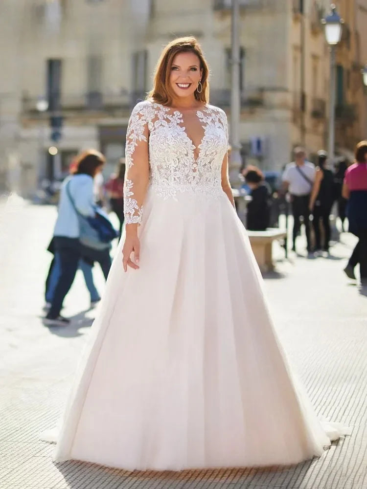 Sheer lace O-neck bridal gown with long sleeves and flowing full skirt