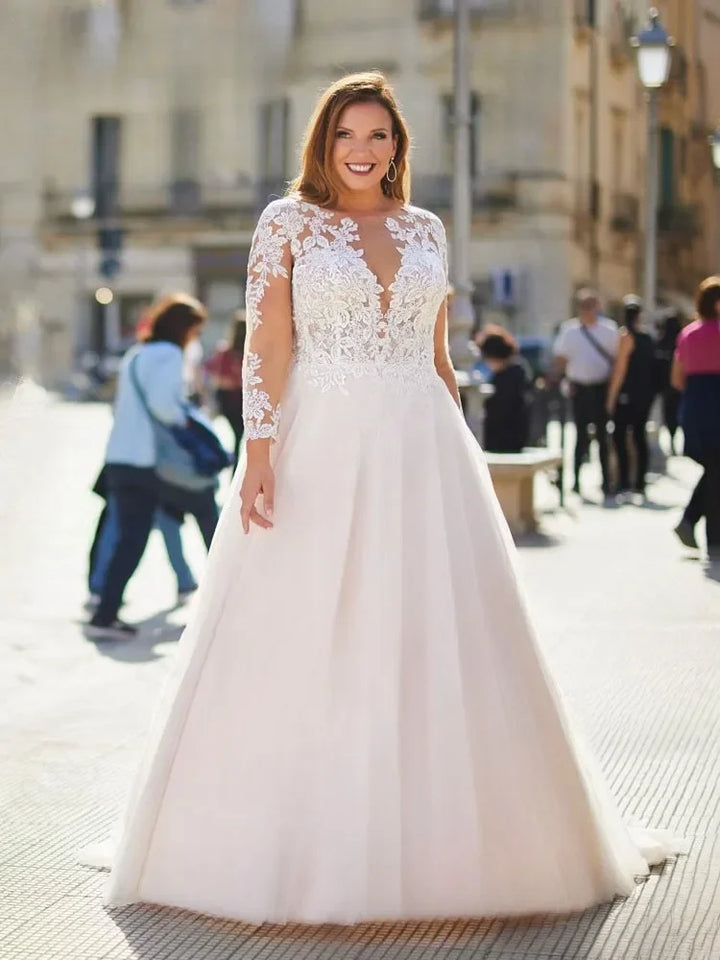 Sheer lace O-neck bridal gown with long sleeves and flowing full skirt