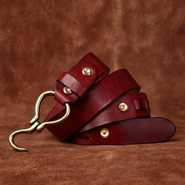 Red leather belt with brass hook buckle, keeper straps, and gold studs