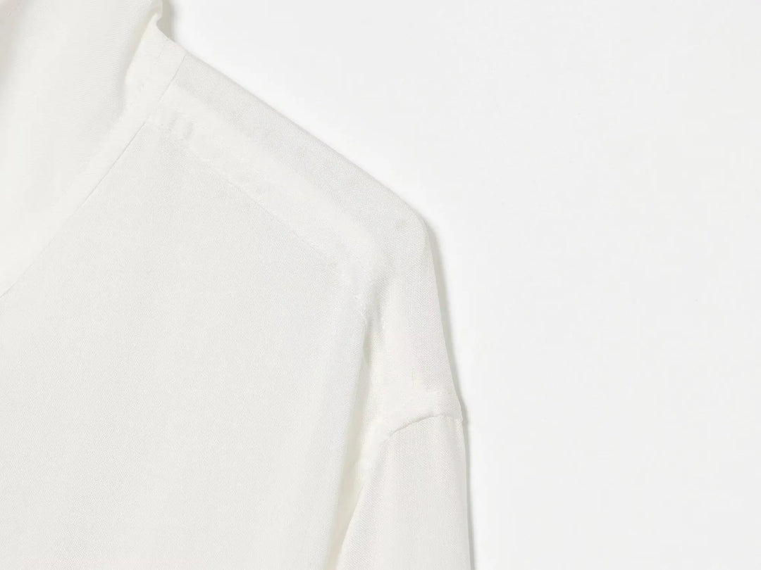 White stand-collar zip-up jacket, close-up shoulder seam and front panel