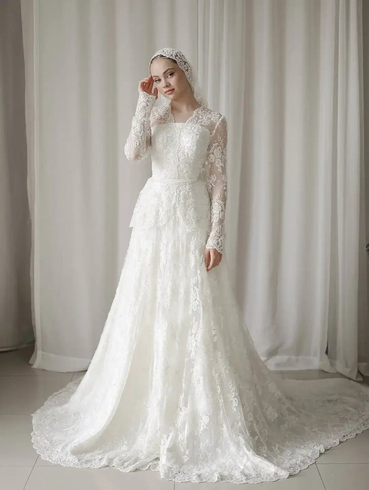 Ivory A-line lace wedding dress with long sleeves and fitted bodice, full skirt.