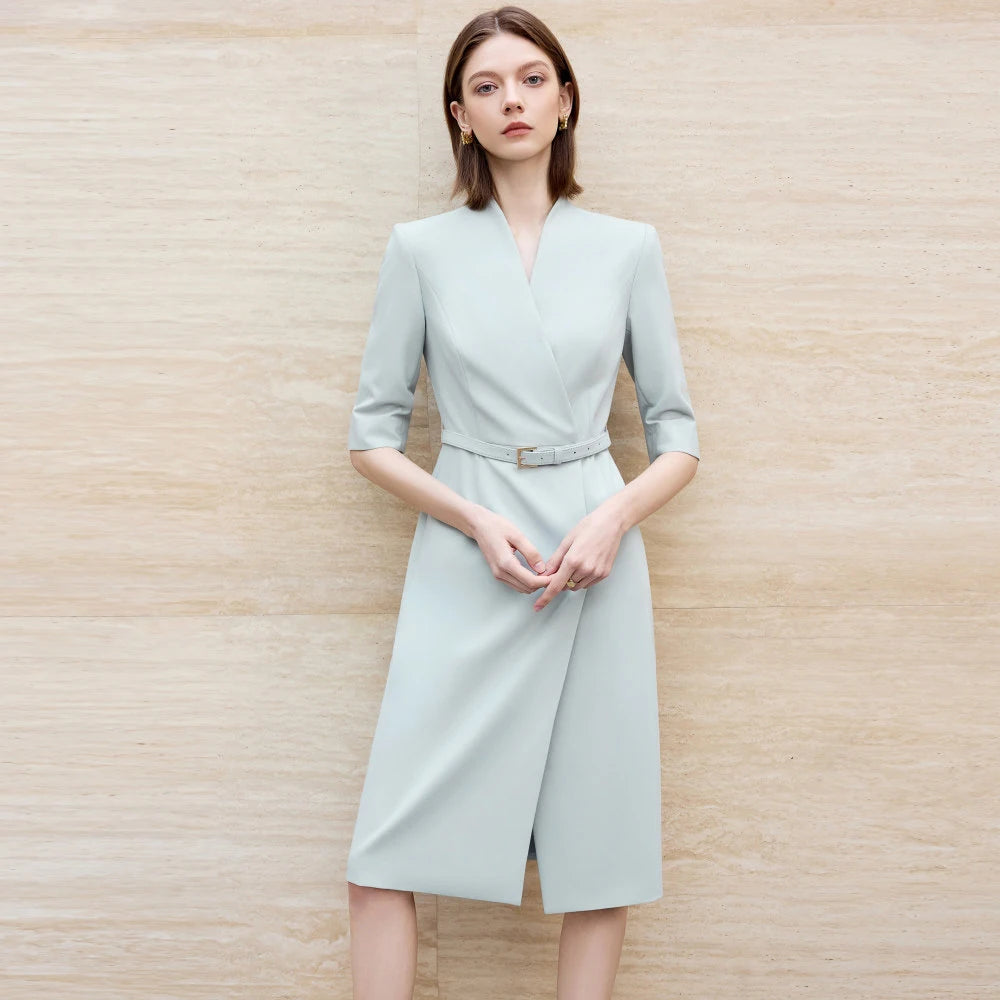 Light blue knee-length skirt suit with V-neck, waist belt, and 3/4 sleeves.
