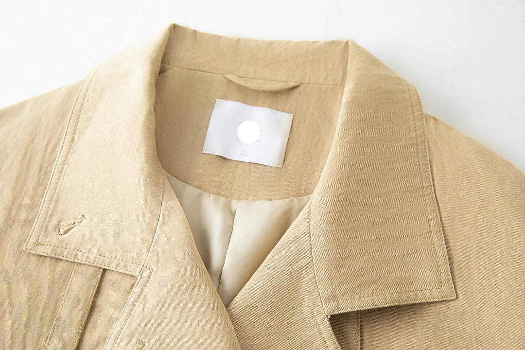 Beige jacket with a visible brand label on a white background
