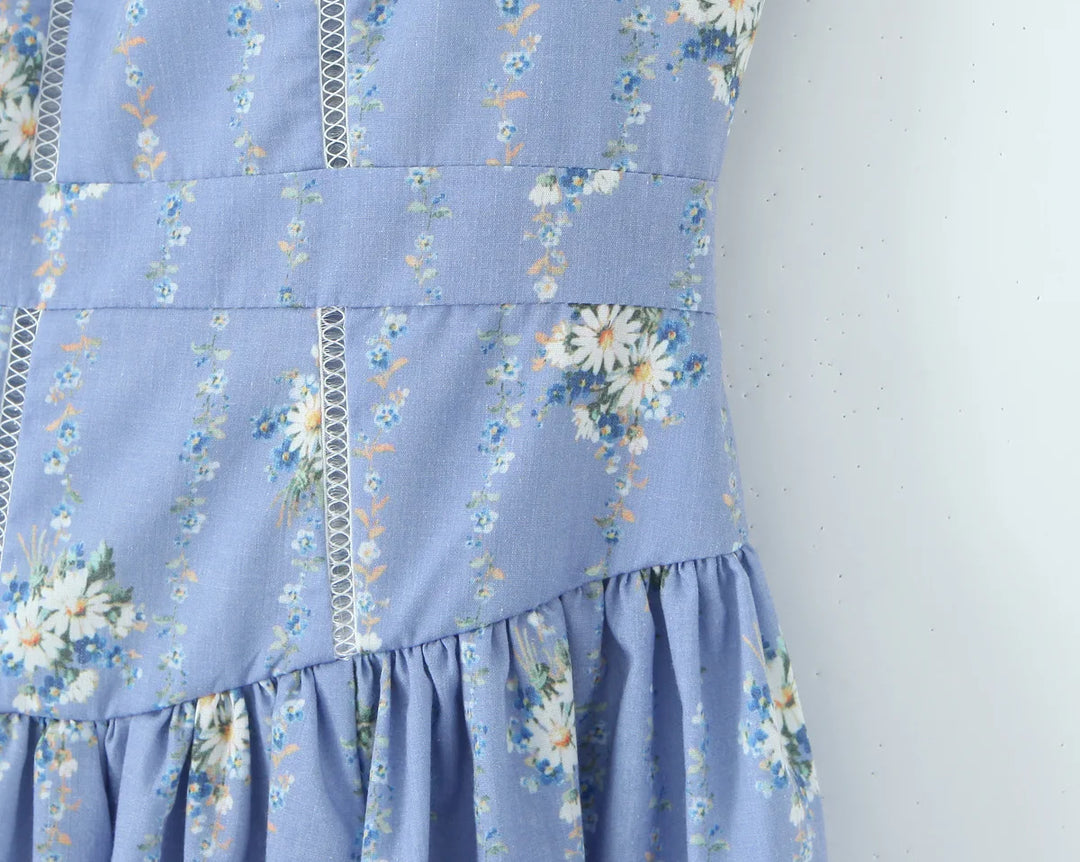 Blue daisy-print sundress bodice with vertical seams and tiered waist