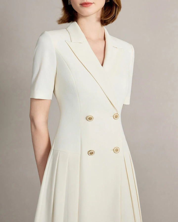 Beige notched-collar dress close-up with gold buttons and short sleeves