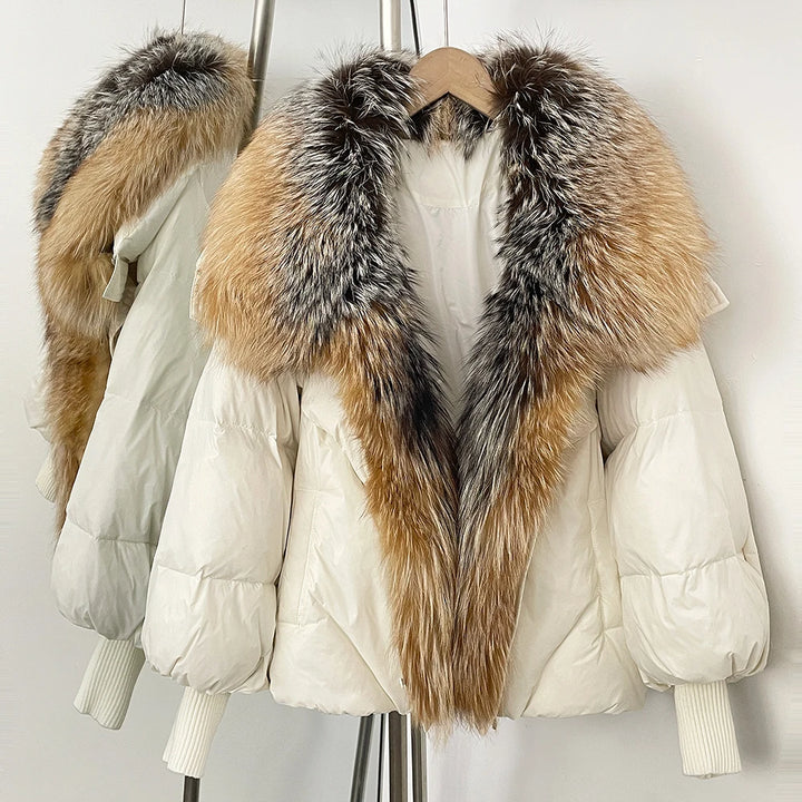 White puffer coat with tan-and-gray faux-fur hood trim, ribbed knit cuffs