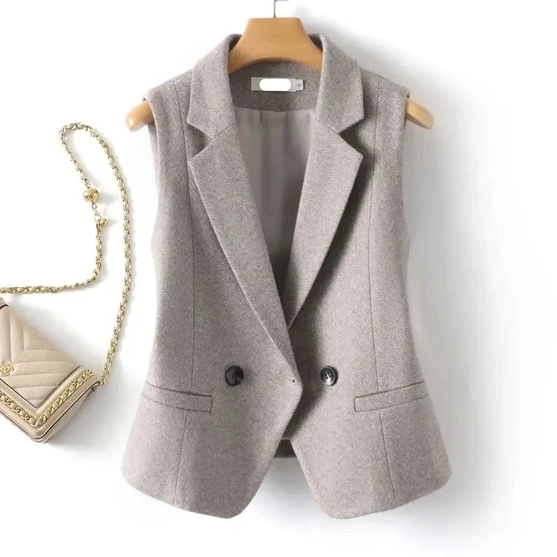 Light beige padded women's waistcoat on hanger with two black button front