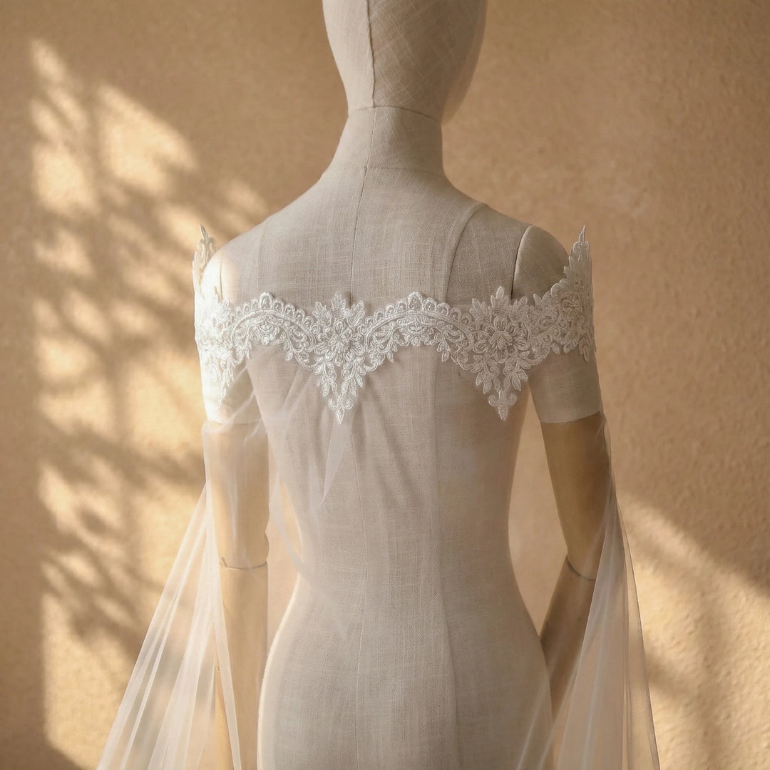 Back view off-white bridal dress with lace applique neckline and sheer tulle veil