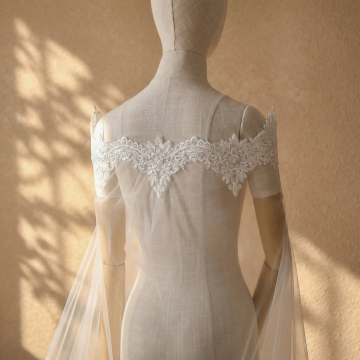 Back view off-white bridal dress with lace applique neckline and sheer tulle veil