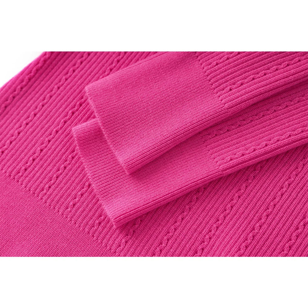 Fuchsia knit sleeve cuff with ribbed hem and cable-like texture
