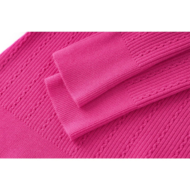 Fuchsia knit sleeve cuff with ribbed hem and cable-like texture
