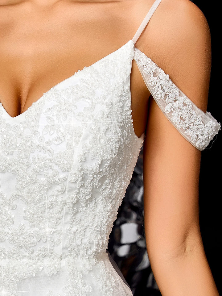 White off-shoulder beaded bridal gown with lace sleeve cuffs and fitted bodice