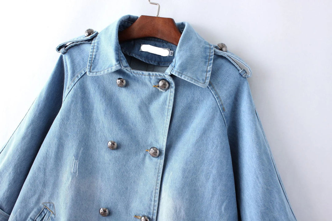 Light blue denim jacket on a hanger against a white background