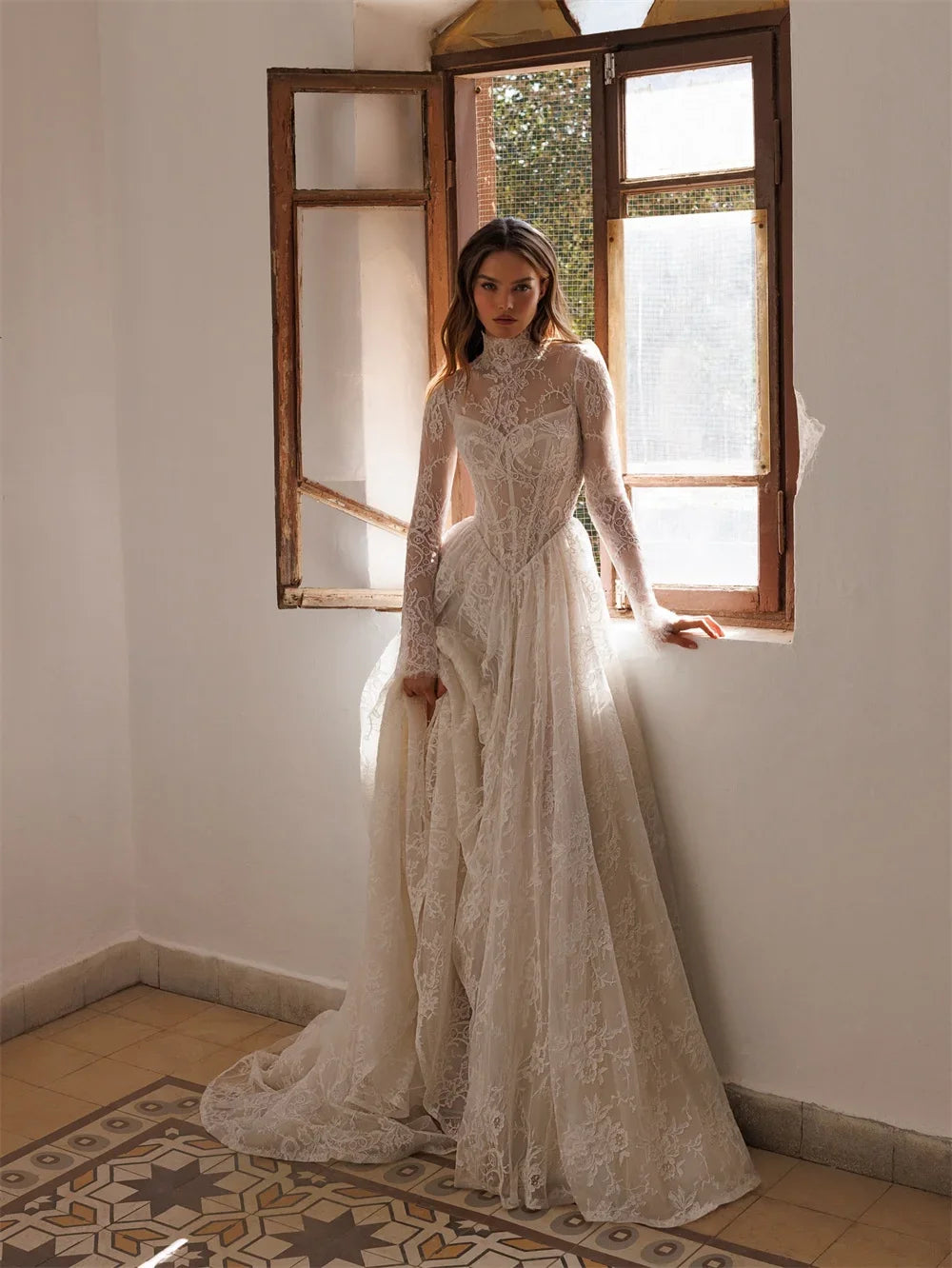 Ivory high-neck lace bridal dress with long sleeves and full flowing skirt