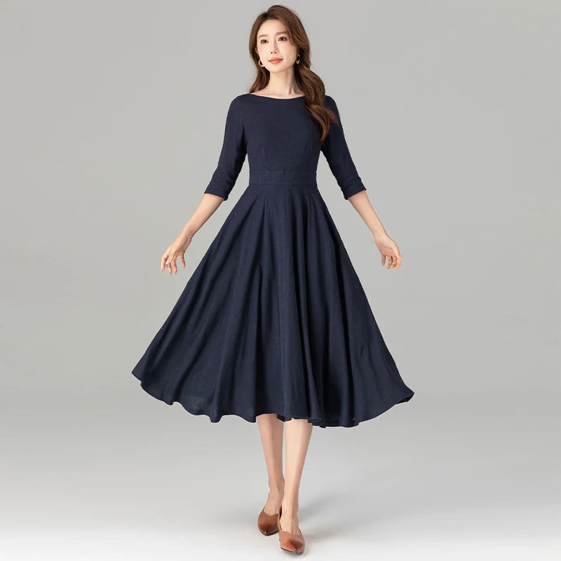 Dark blue midi dress with 3/4 sleeves and pleated flare skirt with belt detail
