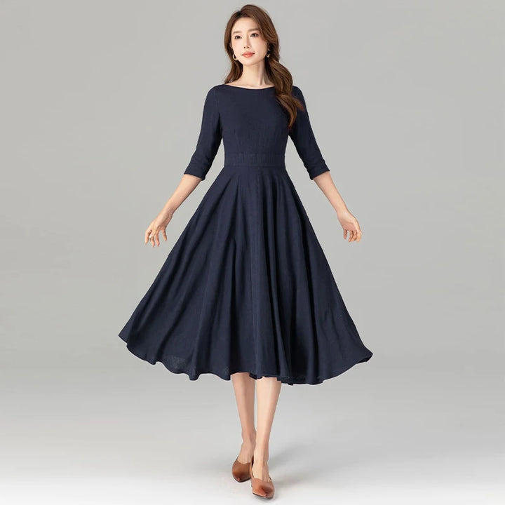 Dark blue midi dress with 3/4 sleeves and pleated flare skirt with belt detail