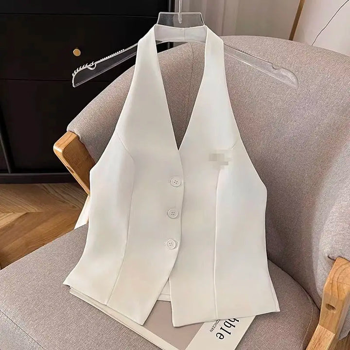 Women’s V-neck blazer vest in white on a hanger, sleeveless with button front
