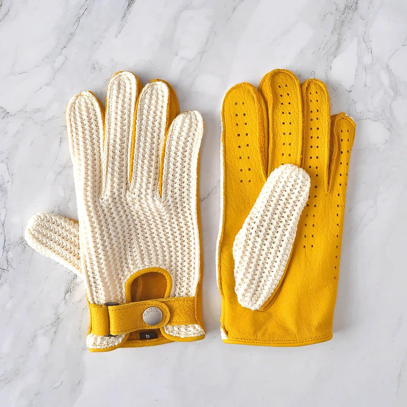 Pair of white knitted gloves with yellow leather backs and perforation detail.