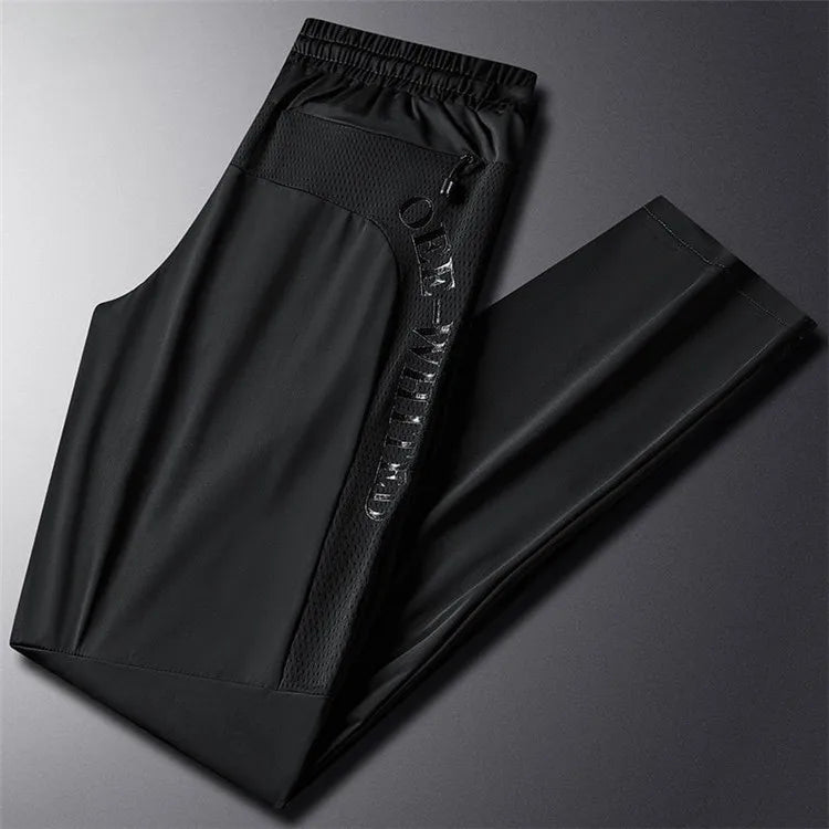 Men's black high-stretch trousers with elastic waistband and front seam detail