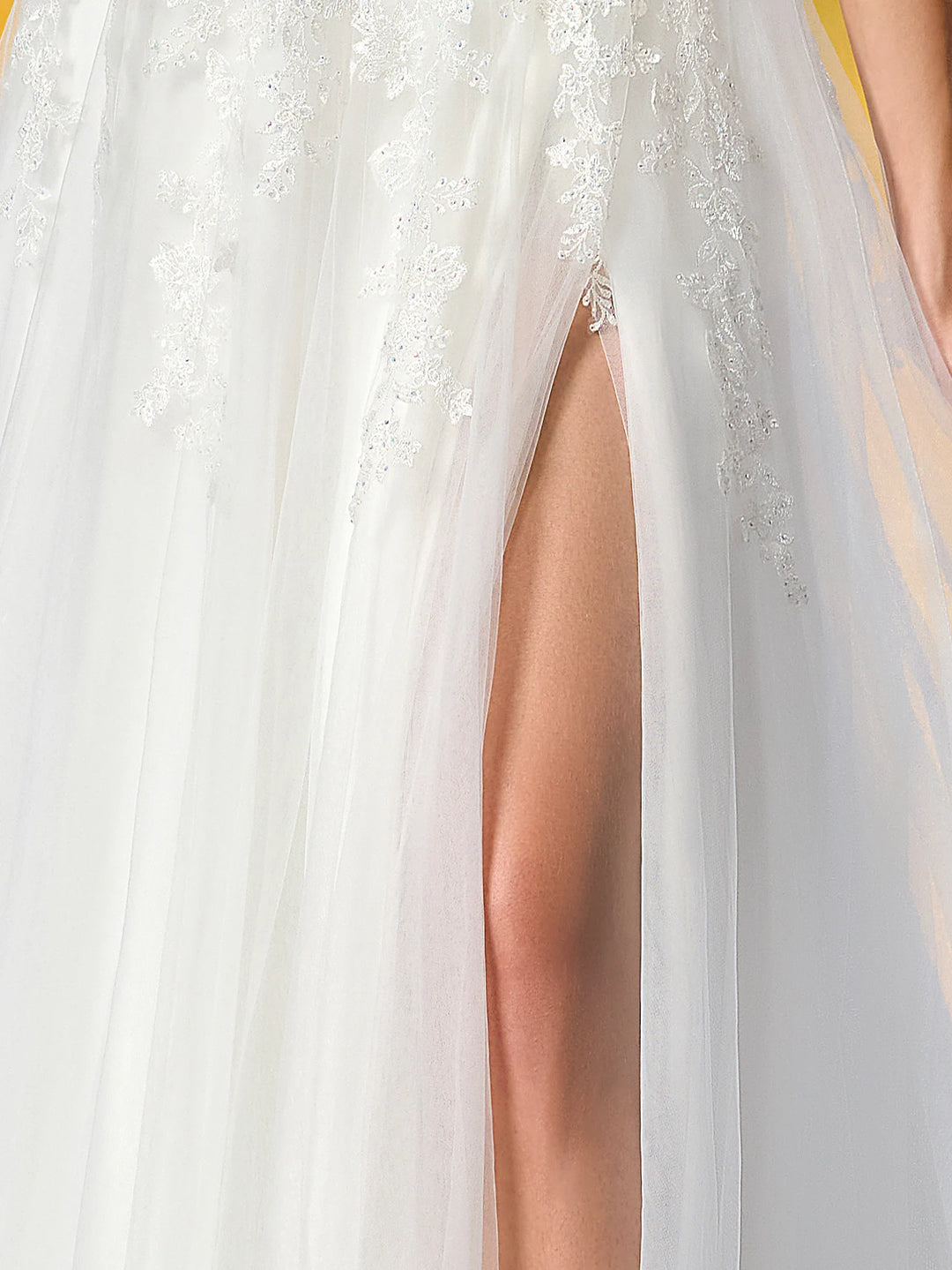 White bridal dress with beaded lace overlay and high side slit on sheer skirt